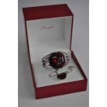 A ladies Baccarat silver bangle set with a red crystal, stamped Baccarat 925, together with a