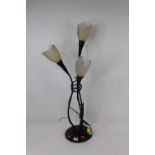 A contemporary continental painted metal table lamp, in the form of three flowers with frosted glass