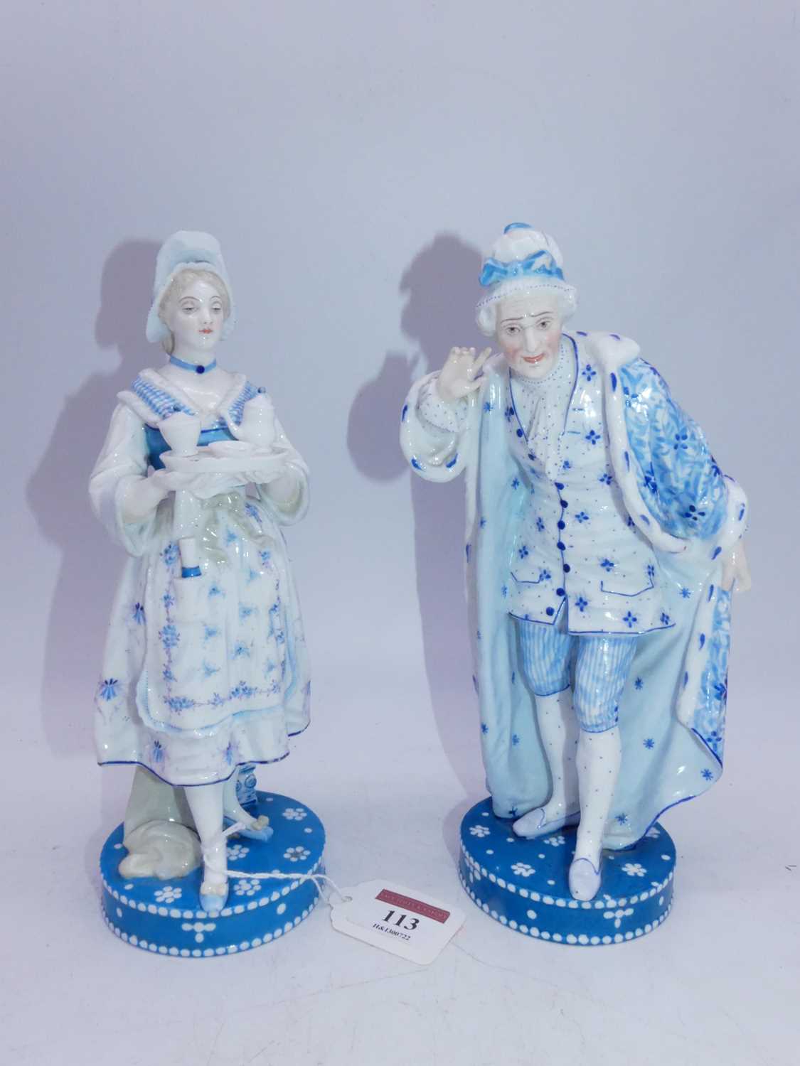 A pair of late 19th century French Vion & Baury porcelain figures, the lady in standing pose holding