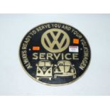 A reproduction cast iron Volkswagen Service advertising wall plaque, dia.24cm