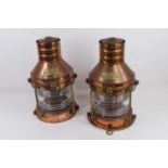 A pair of copper ships lanterns, each bearing a brass plaque "Anchor light No. 1235 Great Britain