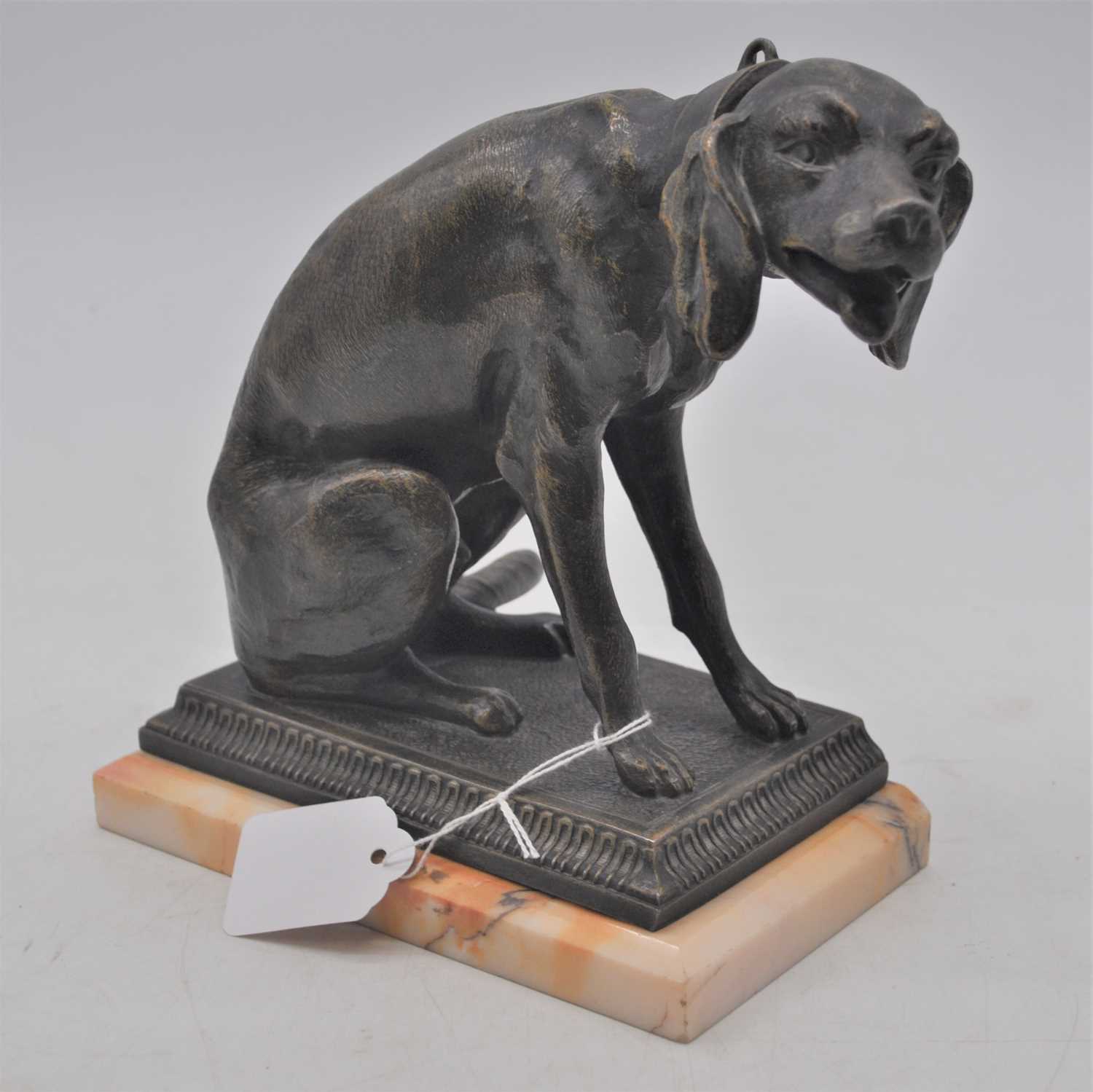 A 20th century bronzed metal model of a seated dog, mounted upon a cavetto moulded base and polished
