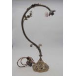 An early 20th century brass table lamp having floral and foliate decoration (lacking shade),