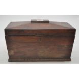 A Regency rosewood tea caddy, of sarcophagus form, the lid lifting to reveal a later glass mixing