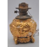 A Royal Worcester porcelain oil lamp font, relief decorated with gilt lily pads, puce mark to the