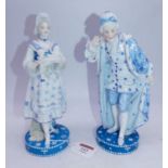 A pair of late 19th century French Vion & Baury porcelain figures, the lady in standing pose holding