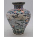 An early 20th century Japanese earthenware vase, enamel decorated with birds amongst flowers,