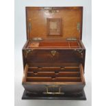 An early 20th century brass mounted oak cased stationery cabinet, the lid lifting to reveal an