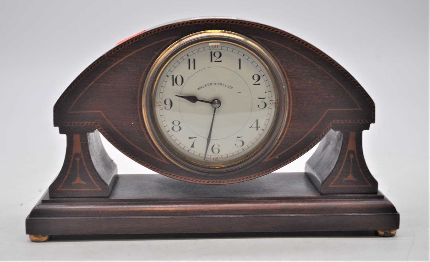 An early 20th century boxwood strung mahogany mantel clock, the dial showing Arabic numerals and