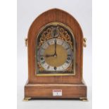 A late 19th century lancet shaped rosewood mantel clock, the boxwood strung case, with twin axe head