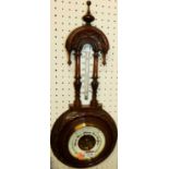 An Edwardian floral relief carved walnut two dial aneroid barometer