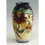 A contemporary Moorcroft Anna Lily pattern pottry vase, of ovoid form, underglaze tube-line