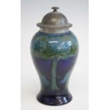 An early 20th century Moorcroft Moonlit Blue pattern pottery vase and cover, the hammered pewter