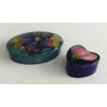 A Moorcroft Clematis pattern pottery tidy and cover, of oval form, tube-line decorated to the lid,