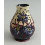 A contemporary Moorcroft pottery vase, of baluster form, underglaze tube-line decorated with