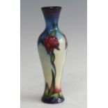 A contemporary Moorcroft Daylily pattern pottery vase, of slender baluster form, underglaze tube-