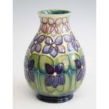 A contemporary Moorcroft Violet pattern pottery vase, designed by Sally Tuffin, of lower baluster