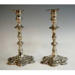 A pair of George II cast silver candlesticks, of fluted and knopped form with removable shell cast