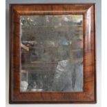 An early 18th century walnut cushion framed wall mirror, with probably original mirrorplate, 46 x