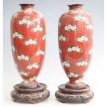 A pair of large Japanese cloisonné vases, each having an everted rim to a tapering body and domed