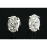 A pair of 18ct white gold diamond oval cluster earrings, each designed to give the illusion of a