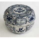 A Chinese blue and white box, of circular form, decorated with alternating panels of flowerheads,