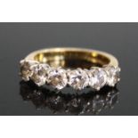 An 18ct yellow and white gold diamond six stone half hoop eternity ring, comprising six round