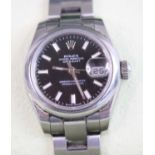 A lady's steel cased automatic Rolex Oyster Perpetual datejust chronometer, having signed black dial