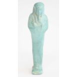 An Egyptian blue faience shabti figure, carved in typical standing pose, New Kingdom in