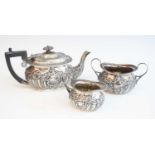 A late Victorian silver three-piece tea service, comprising teapot, twin handled sugar, and milk,