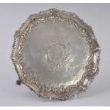 A Victorian silver card waiter, of shaped circular form, having a gadrooned rim and repousse