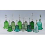 A collection of eleven 19th century Nasilsea type green glass bells, to include an opaque twist