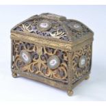 An early 19th century French pierced brass and enamel inset casket, of scrolling pierced form