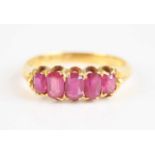 An 18ct yellow gold five stone ruby half hoop eternity ring, featuring five graduated oval faceted