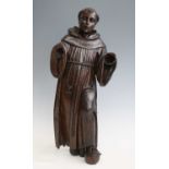 An antique carved oak figure of a standing monk, probably 18th century, being fully robed, h.63cm (