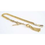 A yellow metal two row ropetwist link Albert chain, with swivel clasp, T bar, and fancy tassel