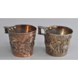 A pair of Greek silver-gilt "Vapheio" style cups, decorated in relief with bull-capturing scenes