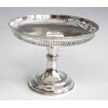 An Edwardian silver comport, the bowl of circular form with alternate scrolling and line pierced