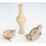 A pottery oil lamp, the body modelled as a head with three spouts and flattened handle, h.7cm,