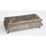 An early 20th century Dutch silver trinket box, of sarcophagus form, the hinged lid repousse