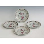 A set of four 18th century Chinese export famille rose porcelain plates, gilt and enamel decorated