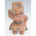 A terracotta pottery figure, modelled as a male in standing pose with right hand raised, pre-