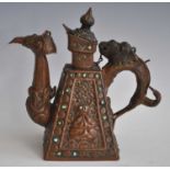 A Buddhist ritual copper ewer, the handle and spout in the form of a makara, the square tapered body