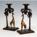 A pair of 19th century bronze and gilt bronze candlesticks, each in the form of a giraffe standing