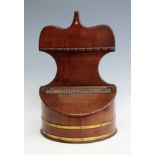 A George III mahogany salt box, the shaped back with spoon rack above a leather hinged and brass