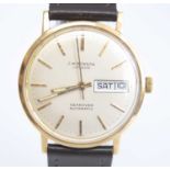 A yellow metal J W Benson Searover automatic wristwatch, having a round cream baton dial and day-