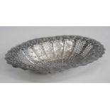 A late Victorian silver basket, of shaped oval form with pierced and repousse scrolling, beaded
