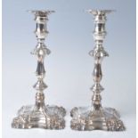 A pair of early 20th century silver plate on copper candlesticks, of ornately shaped knopped form in