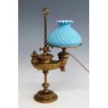 A 19th century German Wild & Wessel brass oil lamp, having a blue quilted glass shade (a/f), the