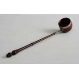 An 18th century toddy ladle, the coquilla nut bowl having silver mounts leading to a turned rosewood